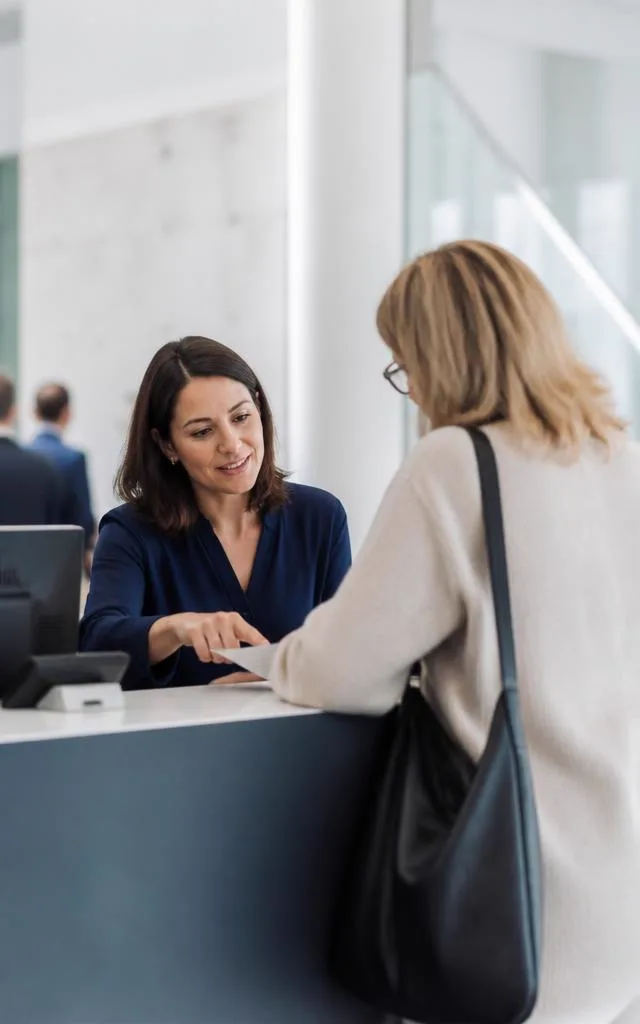 A front-of-house officer handling a resident request on a normal working day